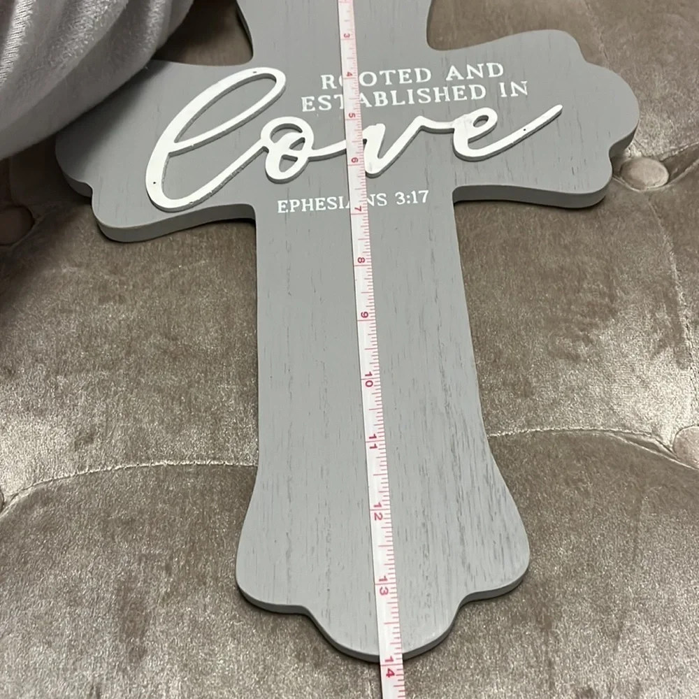 Gray wooden cross with white printing, rooted and established in love, Eph 3:17